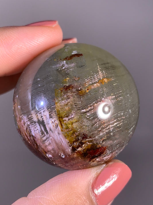 Layered Garden Quartz Sphere with Pink Amphibole Inclusions – Zambia