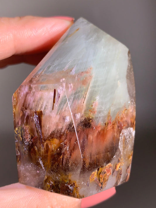 Garden Quartz with Pink Amphibole – A polished tower featuring vibrant layered inclusions and soft pink tones