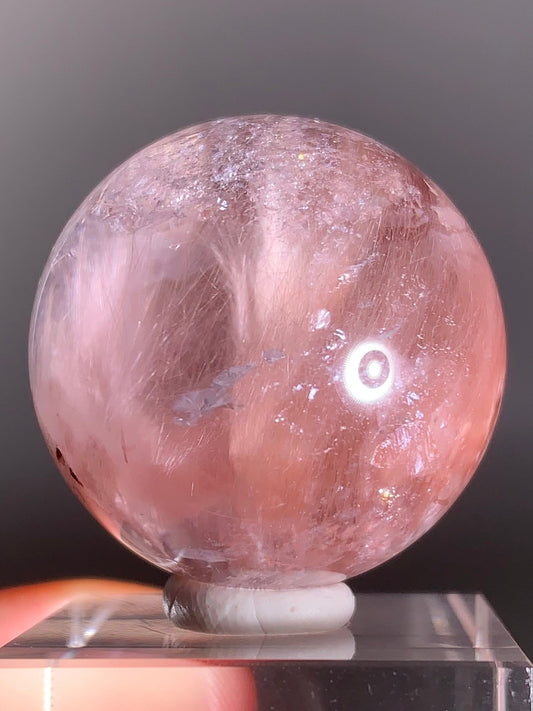 High-Clarity Pink Amphibole Sphere with Silky Textured Inclusions