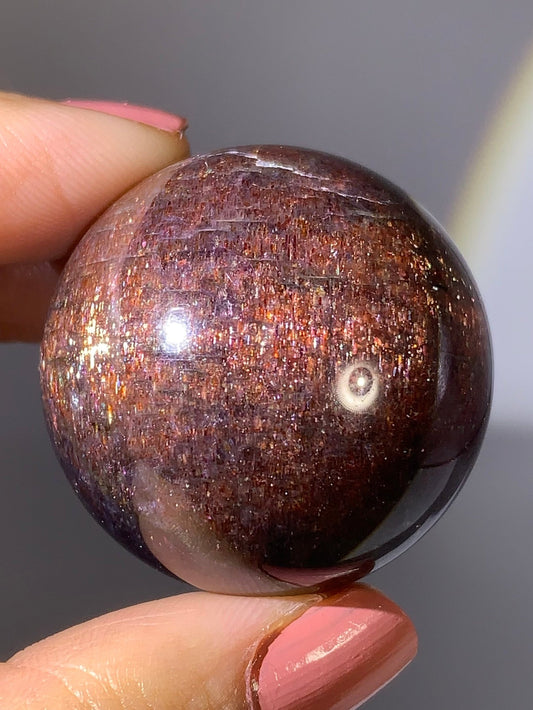Natural High-Grade Galaxy Iolite and Sunstone Bloodshot Sphere from Tanzania