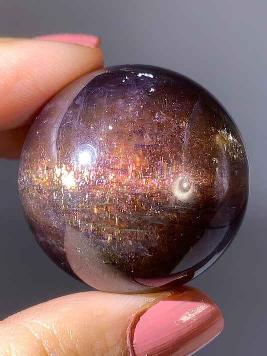 Natural High-Grade Galaxy Iolite and Sunstone Bloodshot Sphere from Tanzania