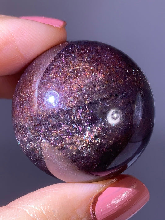 Natural High-Grade Galaxy Iolite and Sunstone Bloodshot Sphere from Tanzania