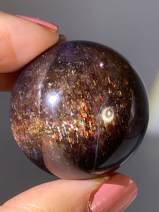 Natural High-Grade Galaxy Iolite and Sunstone Bloodshot Sphere from Tanzania