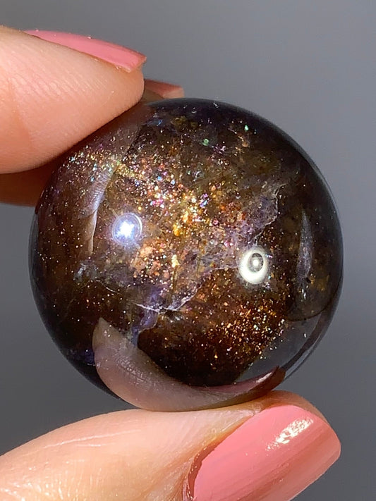 Natural High-Grade Galaxy Iolite and Sunstone Bloodshot Sphere from Tanzania