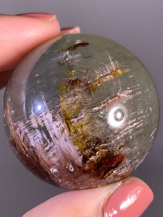Layered Garden Quartz Sphere with Pink Amphibole Inclusions – Zambia